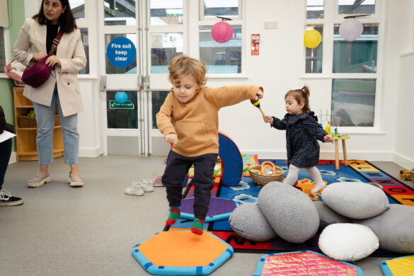 A young boy bouncing on a mat at one of the Children & Family Hubs