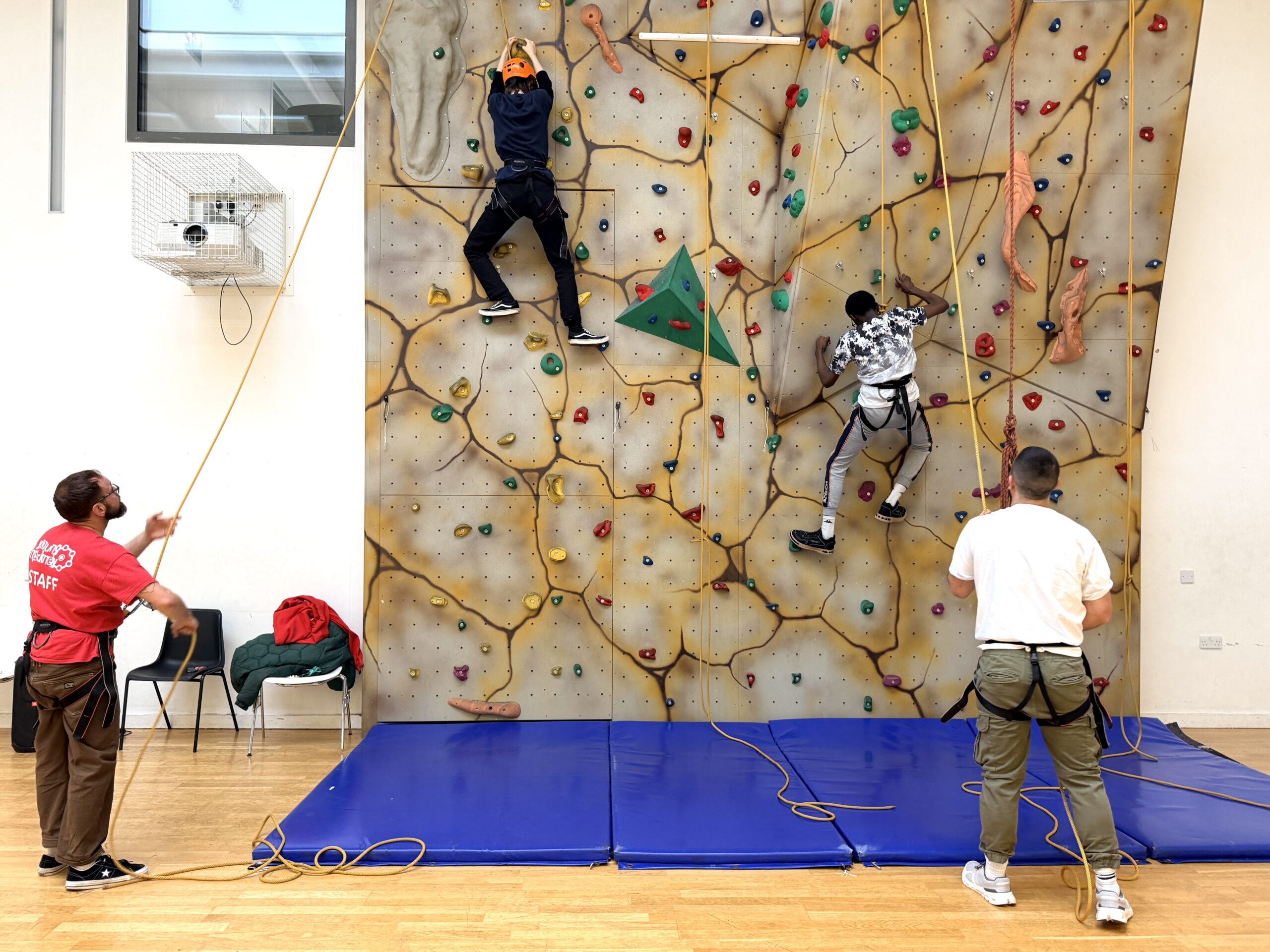 Two young people rock climbing