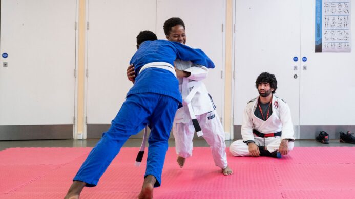 Two young men practicing jiu jistu
