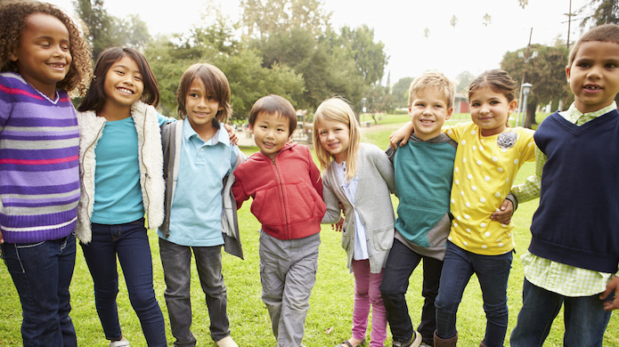 Group Of Young Children Hanging Out In Park